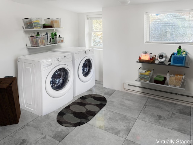 laundry area with laundry area, baseboard heating, and washer and clothes dryer