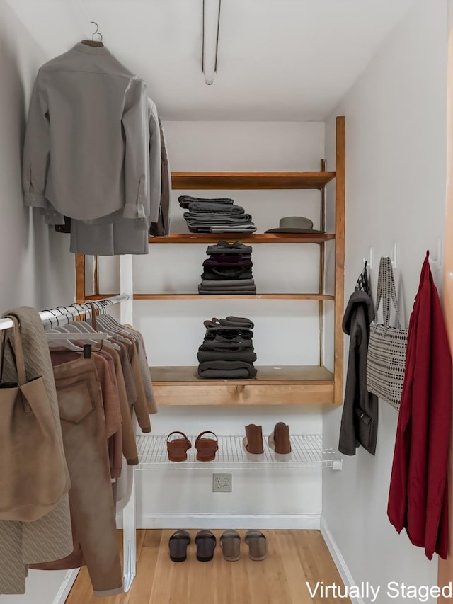 spacious closet with wood finished floors