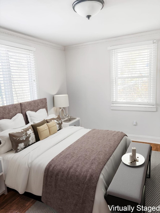 bedroom featuring wood finished floors and baseboards