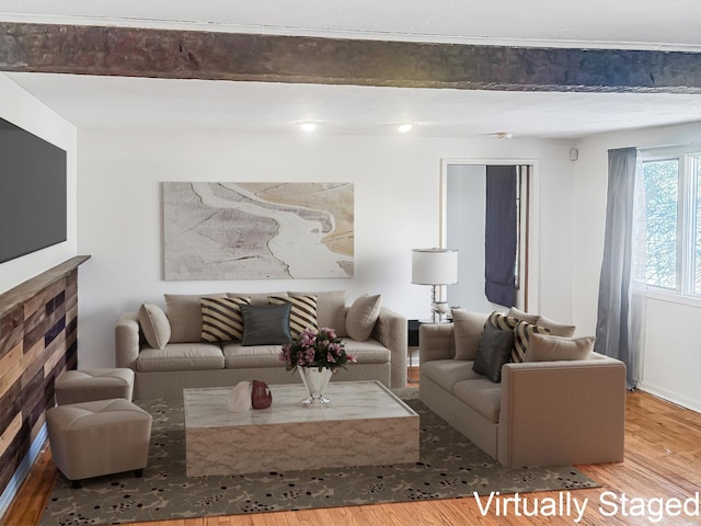 living area with beamed ceiling and wood finished floors