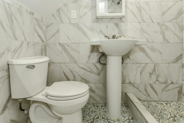full bath with toilet and a stall shower