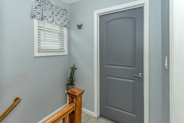 interior space with baseboards and light wood-style floors