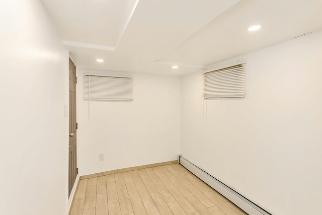 unfurnished room with light wood-style flooring, recessed lighting, baseboards, and a baseboard radiator