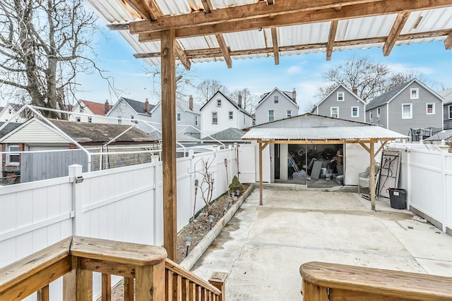 view of patio with a gazebo, a residential view, and a fenced backyard