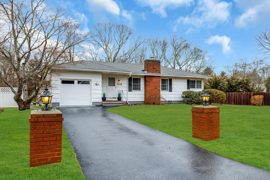 7 Howell Pl, Speonk, NY 11934 - ranch-style home featuring fence, an attached garage, aphalt driveway, a front lawn, and a chimney