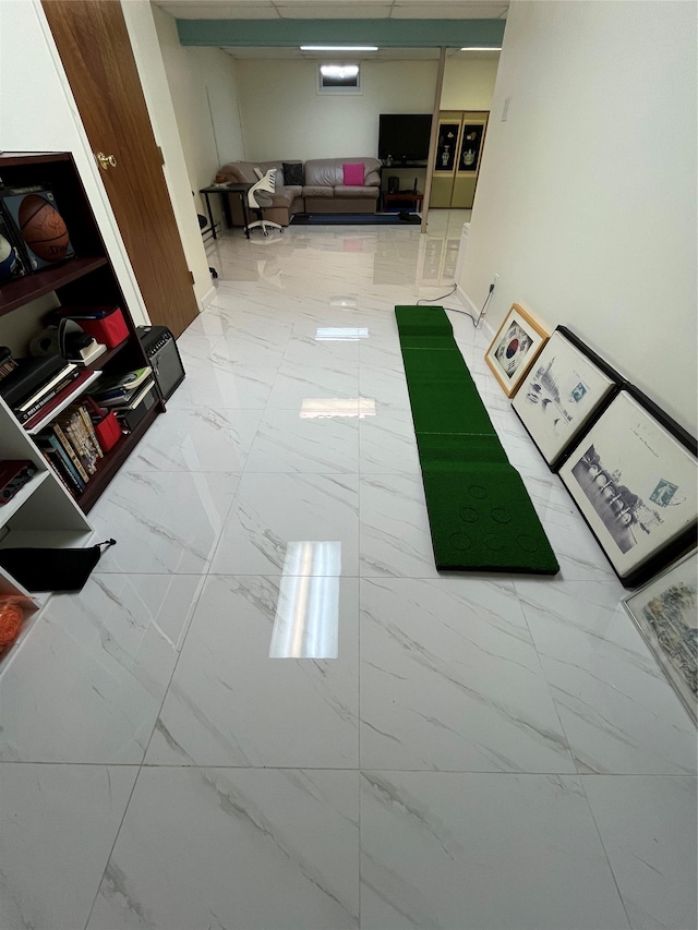 hallway featuring marble finish floor