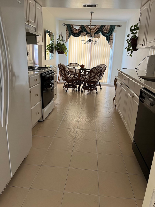 kitchen with freestanding refrigerator, under cabinet range hood, electric stove, dishwasher, and a notable chandelier