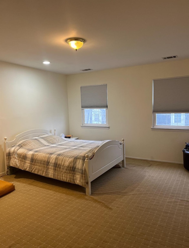 carpeted bedroom with recessed lighting, visible vents, and baseboards