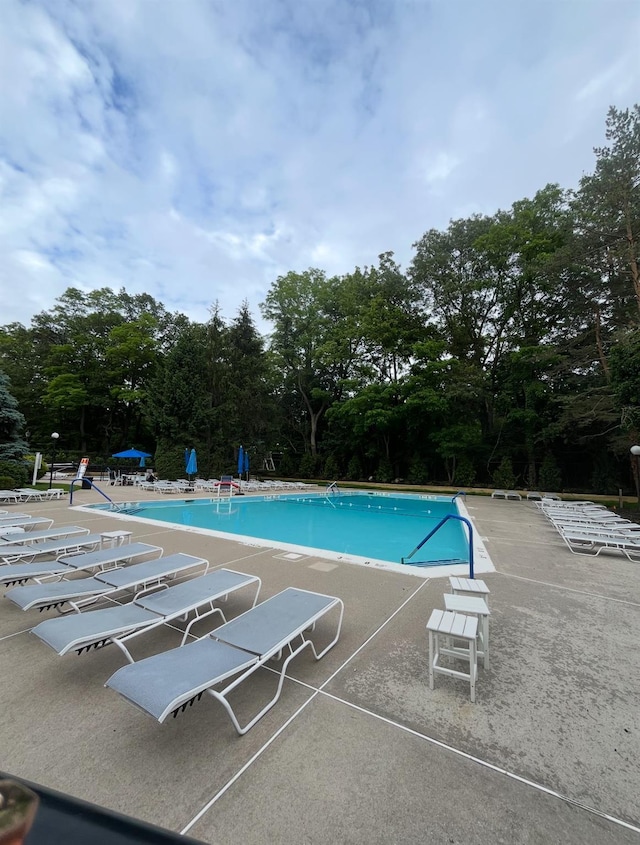 109 Glen Way, Syosset, NY 11791 - community pool featuring a patio and view of scattered trees