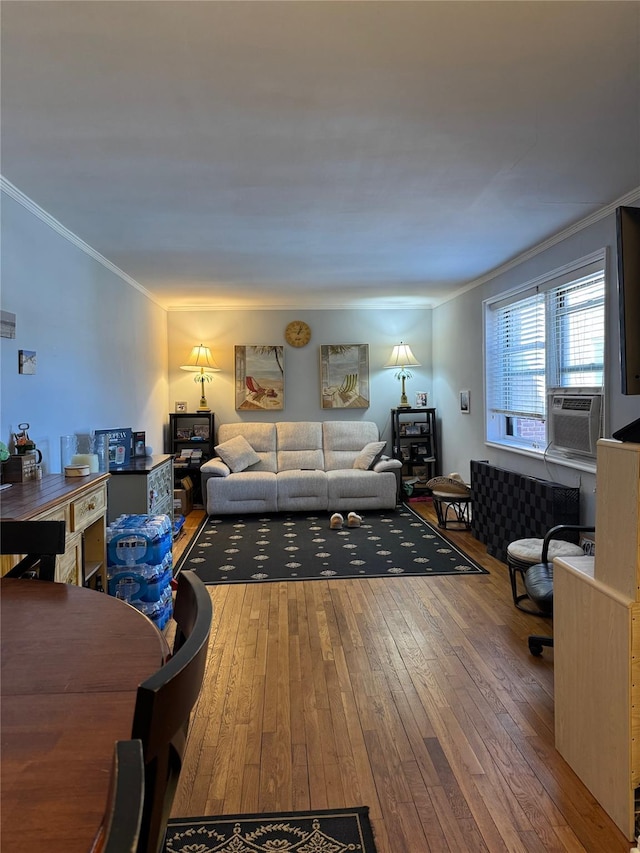 living room with crown molding and hardwood / wood-style floors