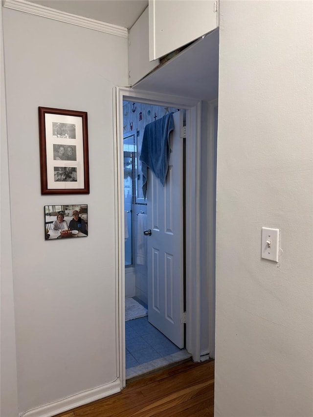 hall featuring crown molding and dark wood-type flooring