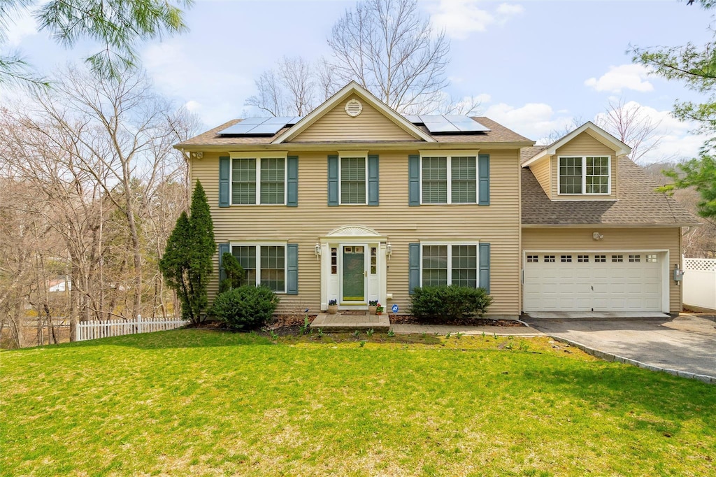 48 Wharton Dr, Cortlandt Manor, NY 10567 - colonial-style house with a front yard, fence, solar panels, and driveway