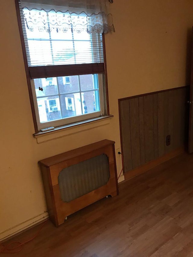 room details with radiator heating unit and wood finished floors