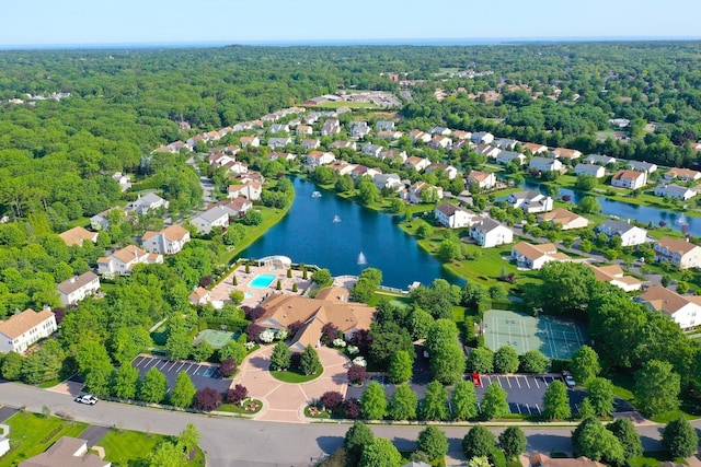 birds eye view of property featuring a forest view, a residential view, and a water view