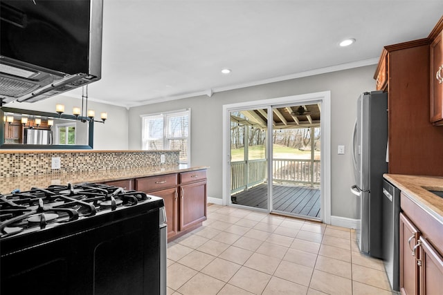 kitchen with light tile patterned floors, ornamental molding, baseboards, backsplash, and appliances with stainless steel finishes