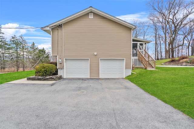 view of home's exterior with aphalt driveway, a garage, stairway, and a yard