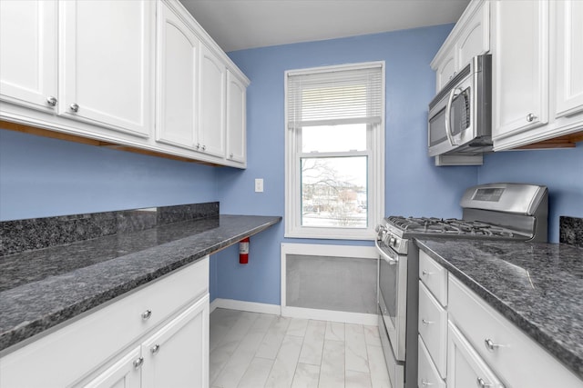 laundry room featuring marble finish floor and baseboards