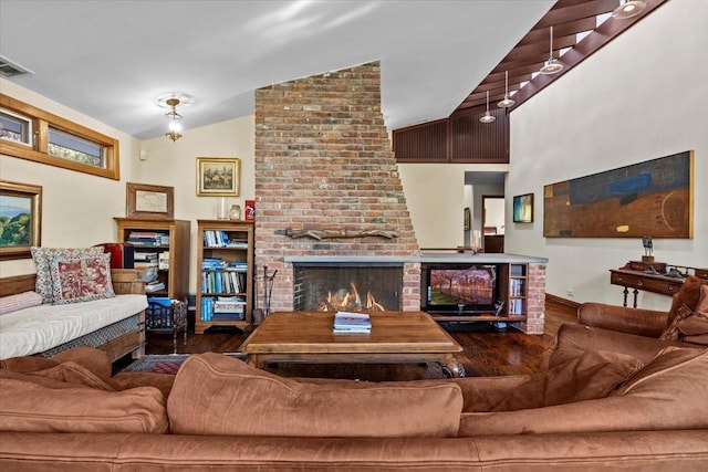 714 Ladd Rd, Bronx, NY 10471 - living area with lofted ceiling, a fireplace, and wood finished floors