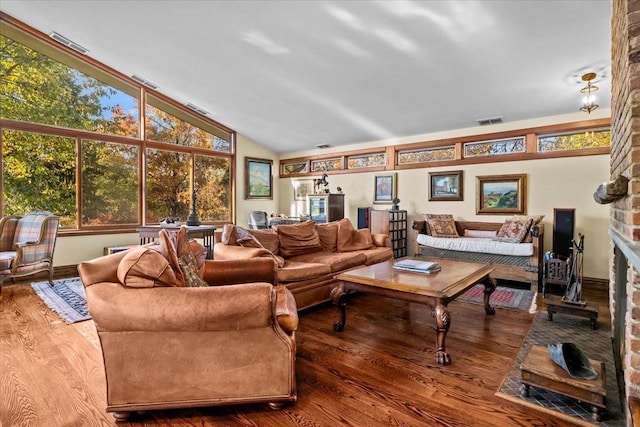 714 Ladd Rd, Bronx, NY 10471 - living area featuring wood finished floors, vaulted ceiling, and a brick fireplace