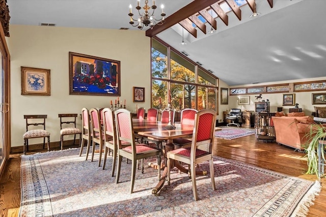 714 Ladd Rd, Bronx, NY 10471 - dining area with wood finished floors, a chandelier, and high vaulted ceiling