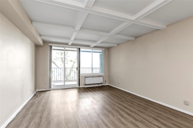 spare room with baseboards, wood finished floors, beam ceiling, and coffered ceiling