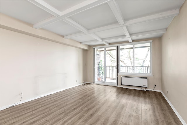 spare room with beamed ceiling, baseboards, coffered ceiling, and wood finished floors