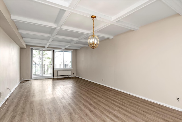 empty room featuring baseboards, a notable chandelier, beam ceiling, wood finished floors, and coffered ceiling
