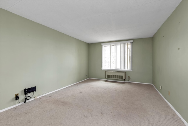 unfurnished room with baseboards and carpet flooring