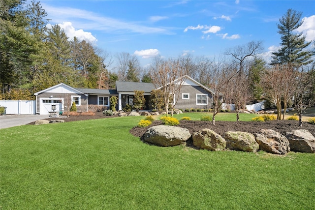 ranch-style house with driveway, a front yard, a garage, and fence