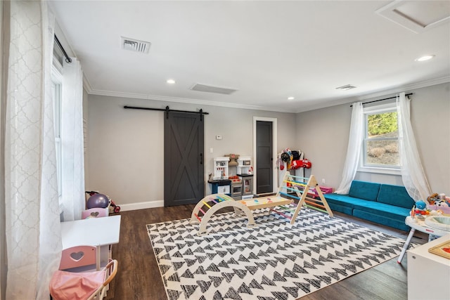 rec room featuring visible vents, crown molding, a barn door, recessed lighting, and wood finished floors