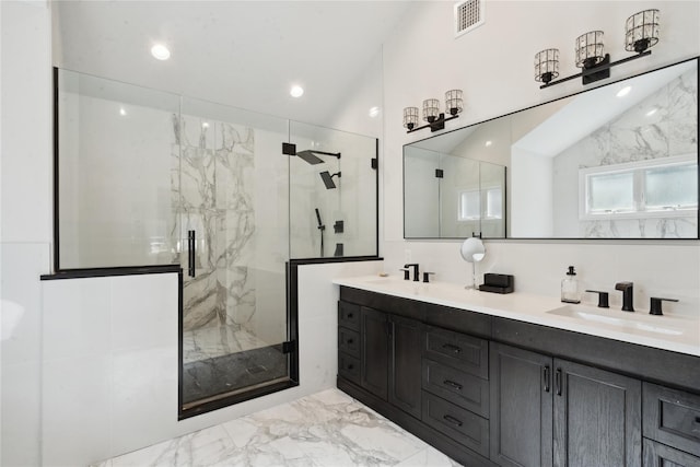 full bathroom with visible vents, a marble finish shower, lofted ceiling, a sink, and marble finish floor