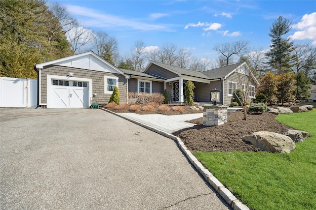 ranch-style house with an attached garage, fence, and driveway