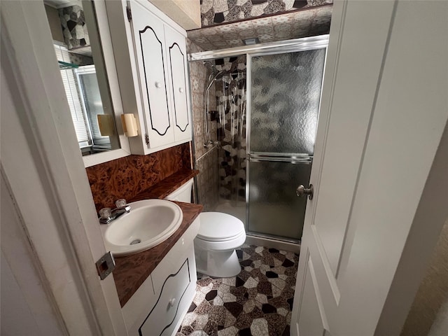 full bath with toilet, a stall shower, and vanity