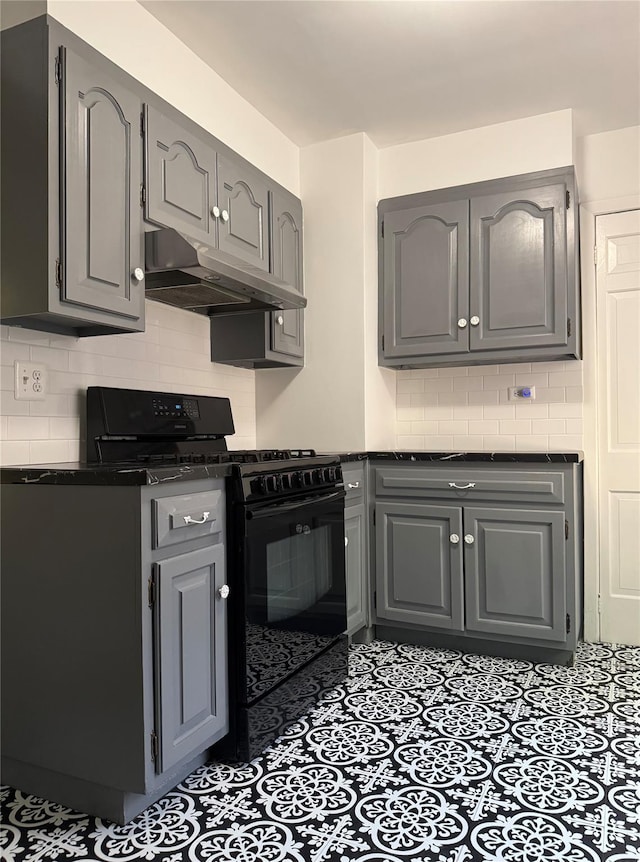 6 Sedgwick Ave, Yonkers, NY 10705 - kitchen with dark countertops, gas stove, backsplash, under cabinet range hood, and gray cabinetry