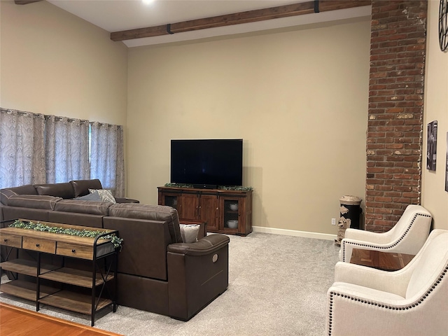 living area with beam ceiling, carpet, and baseboards