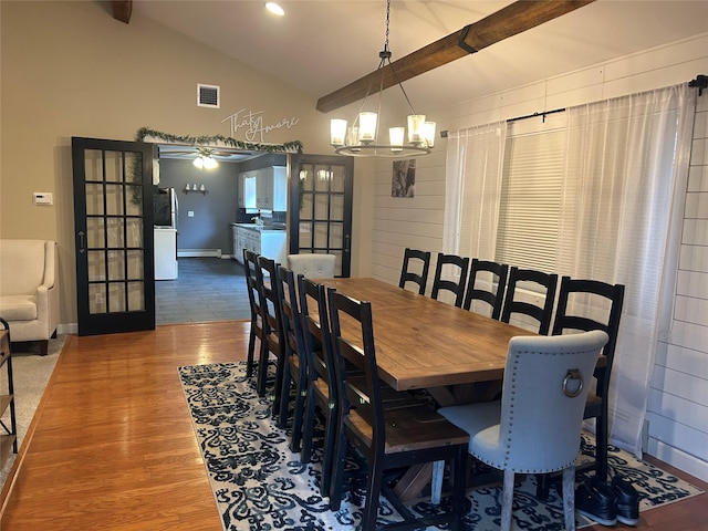 dining room with visible vents, beamed ceiling, wood finished floors, french doors, and a baseboard radiator