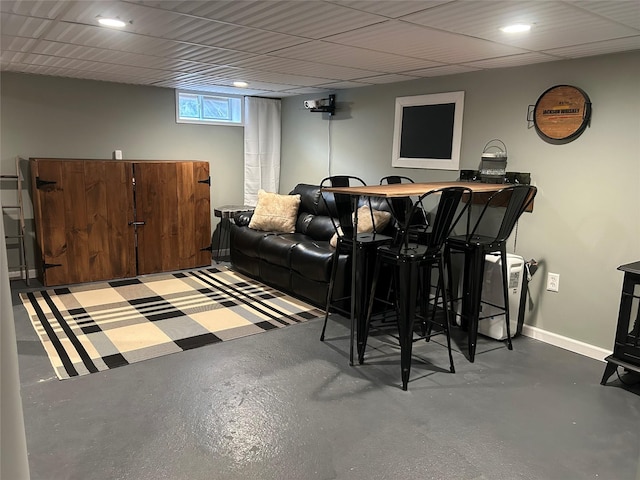 living area with recessed lighting, baseboards, and finished concrete flooring