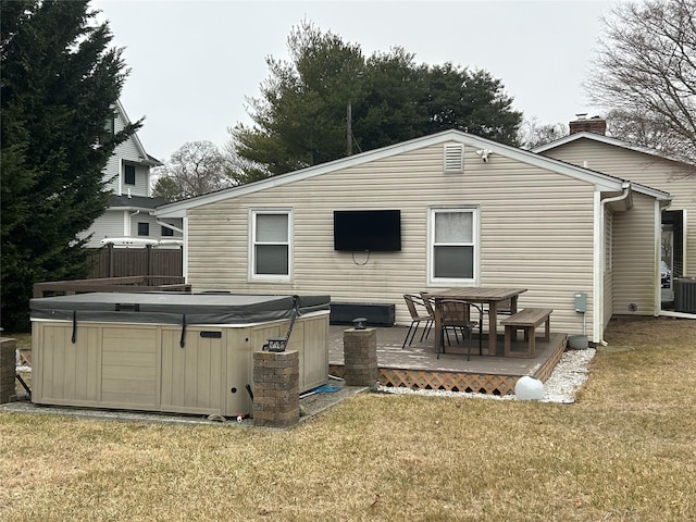 rear view of house featuring a wooden deck, central air condition unit, a yard, and a hot tub