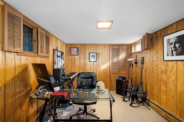 carpeted home office featuring wood walls and baseboard heating