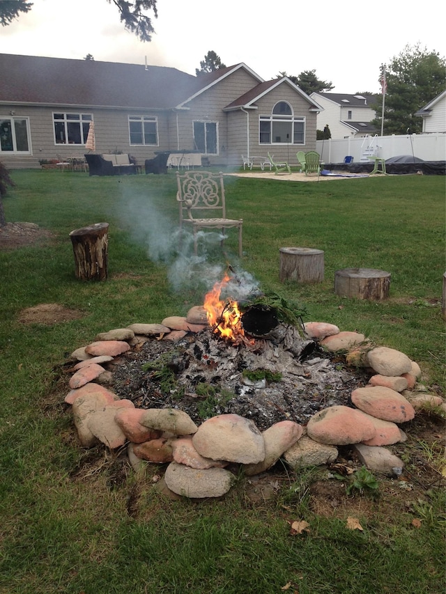 view of yard with an outdoor fire pit and fence