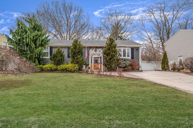 view of front of home with stone siding, driveway, and a front yard