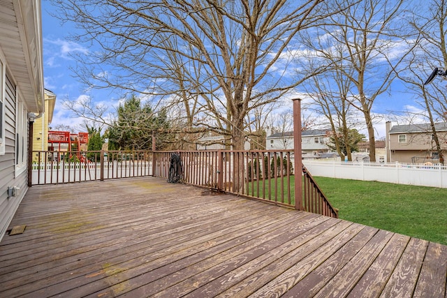 deck featuring a yard, a residential view, and fence