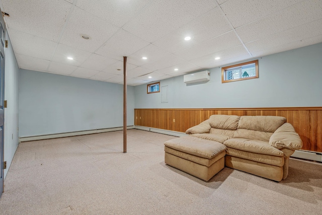 carpeted living area featuring wood walls, a wall mounted air conditioner, baseboard heating, recessed lighting, and wainscoting