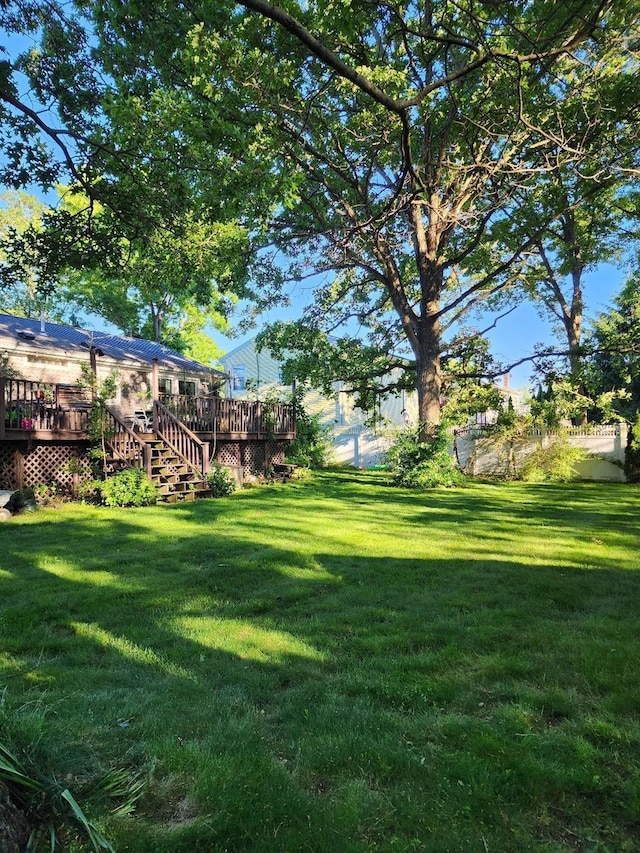 view of yard with stairs and a wooden deck