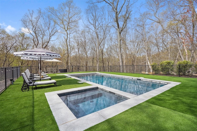 view of swimming pool with a lawn, an in ground hot tub, fence, and a fenced in pool