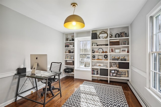office area featuring wood finished floors and a baseboard radiator
