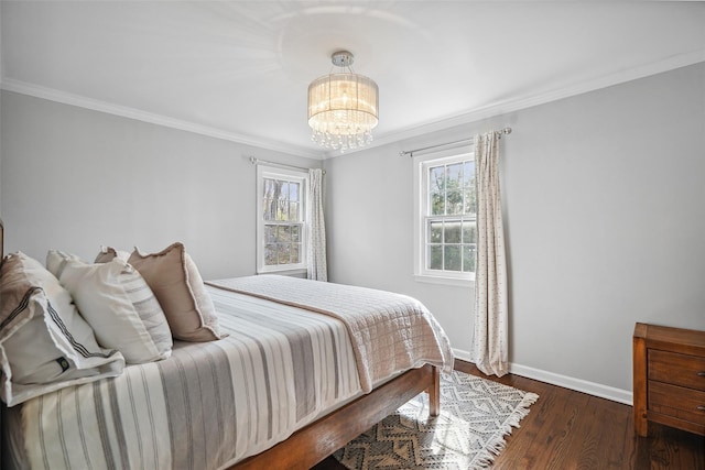 bedroom with crown molding, baseboards, an inviting chandelier, and wood finished floors