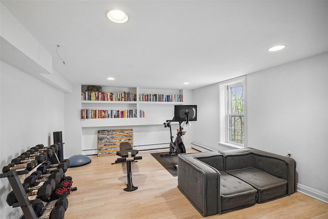 workout area featuring recessed lighting, a baseboard heating unit, baseboard heating, and wood finished floors