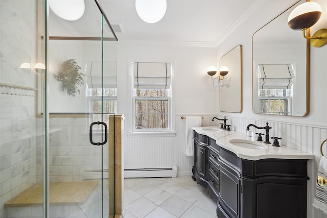 bathroom featuring double vanity, a sink, crown molding, and a stall shower