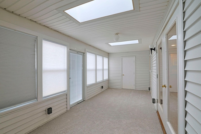 unfurnished sunroom with a skylight